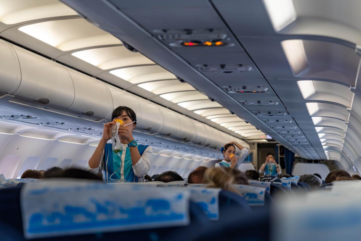 Flight attendants demonstrating safety procedures