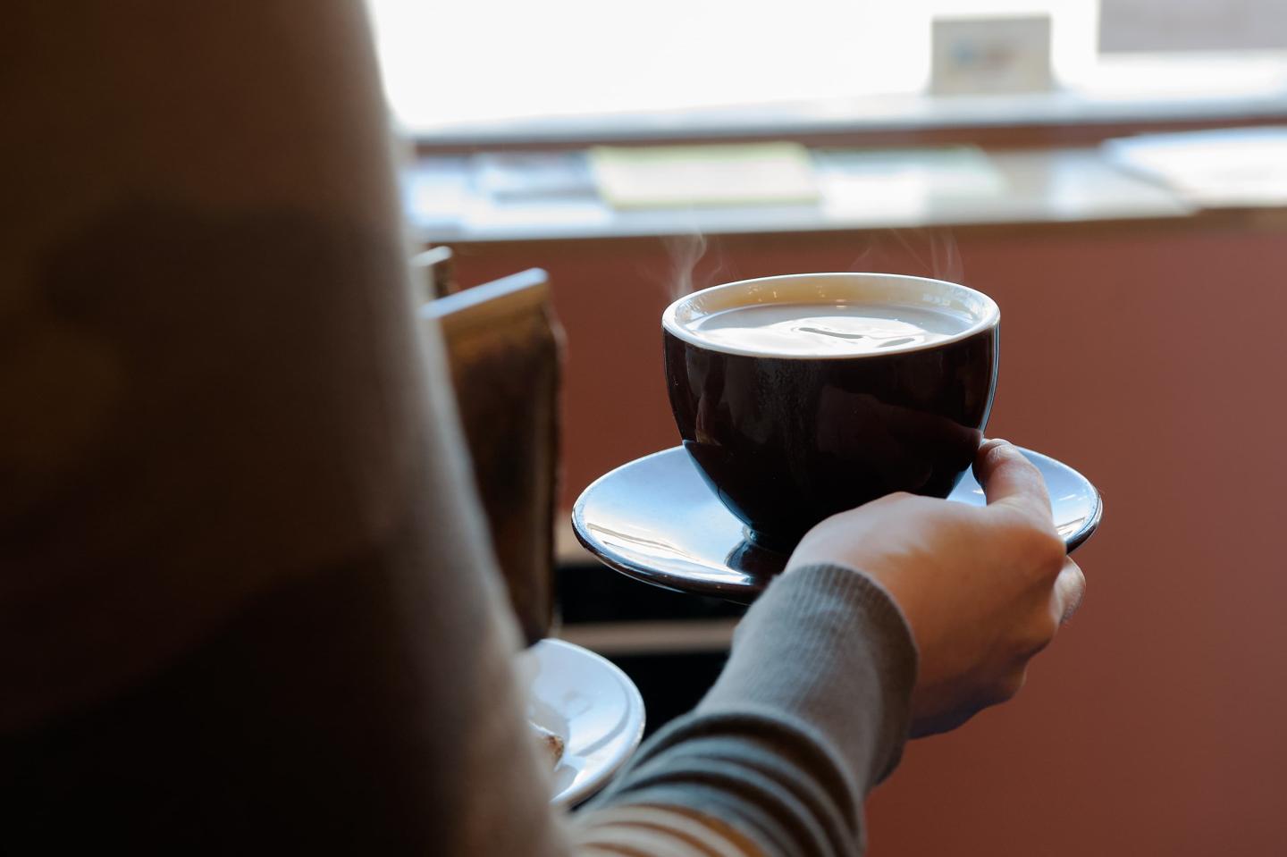 A person holding a cup of coffee