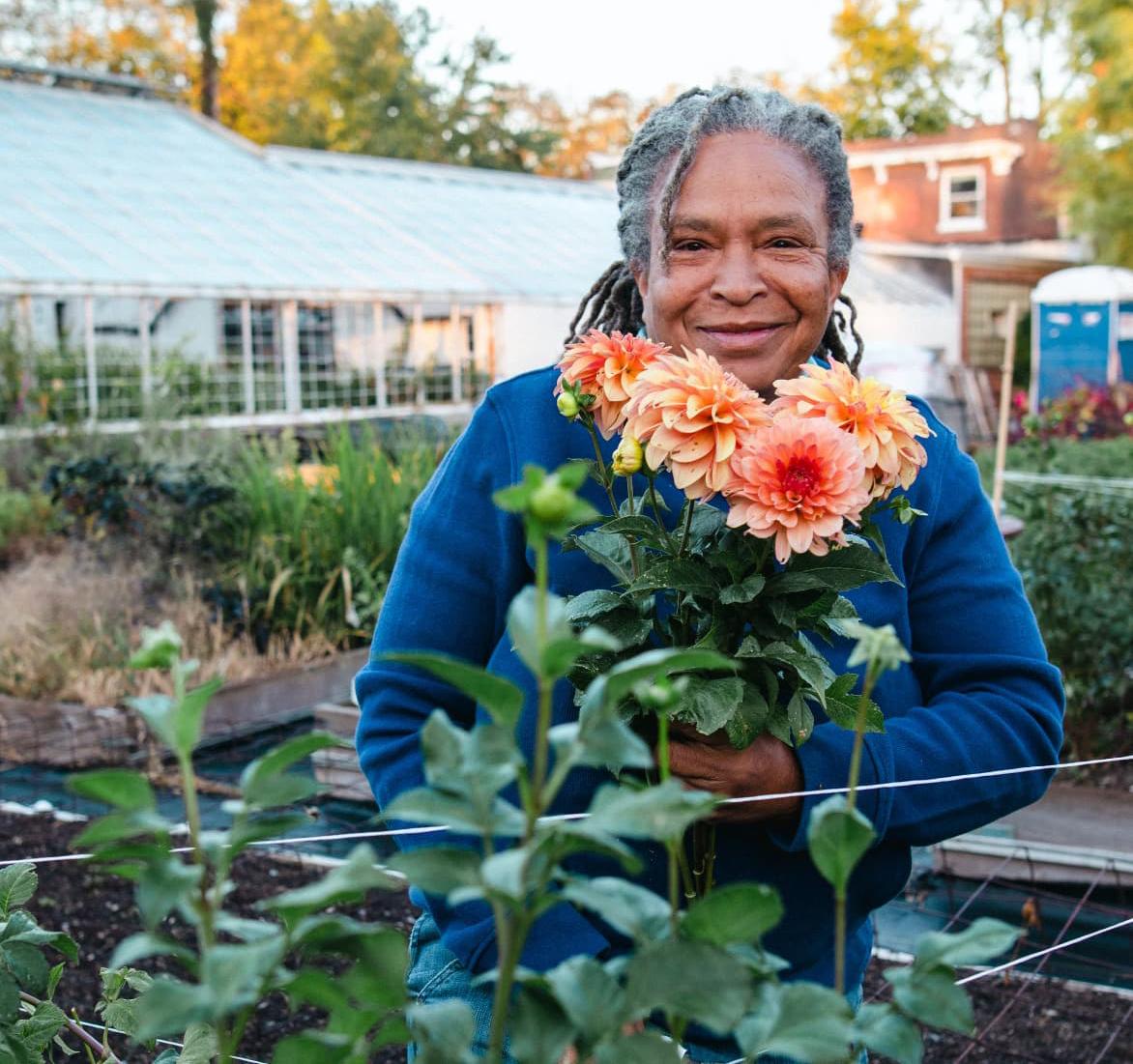 Mimo Davis holding freshly cut flowers