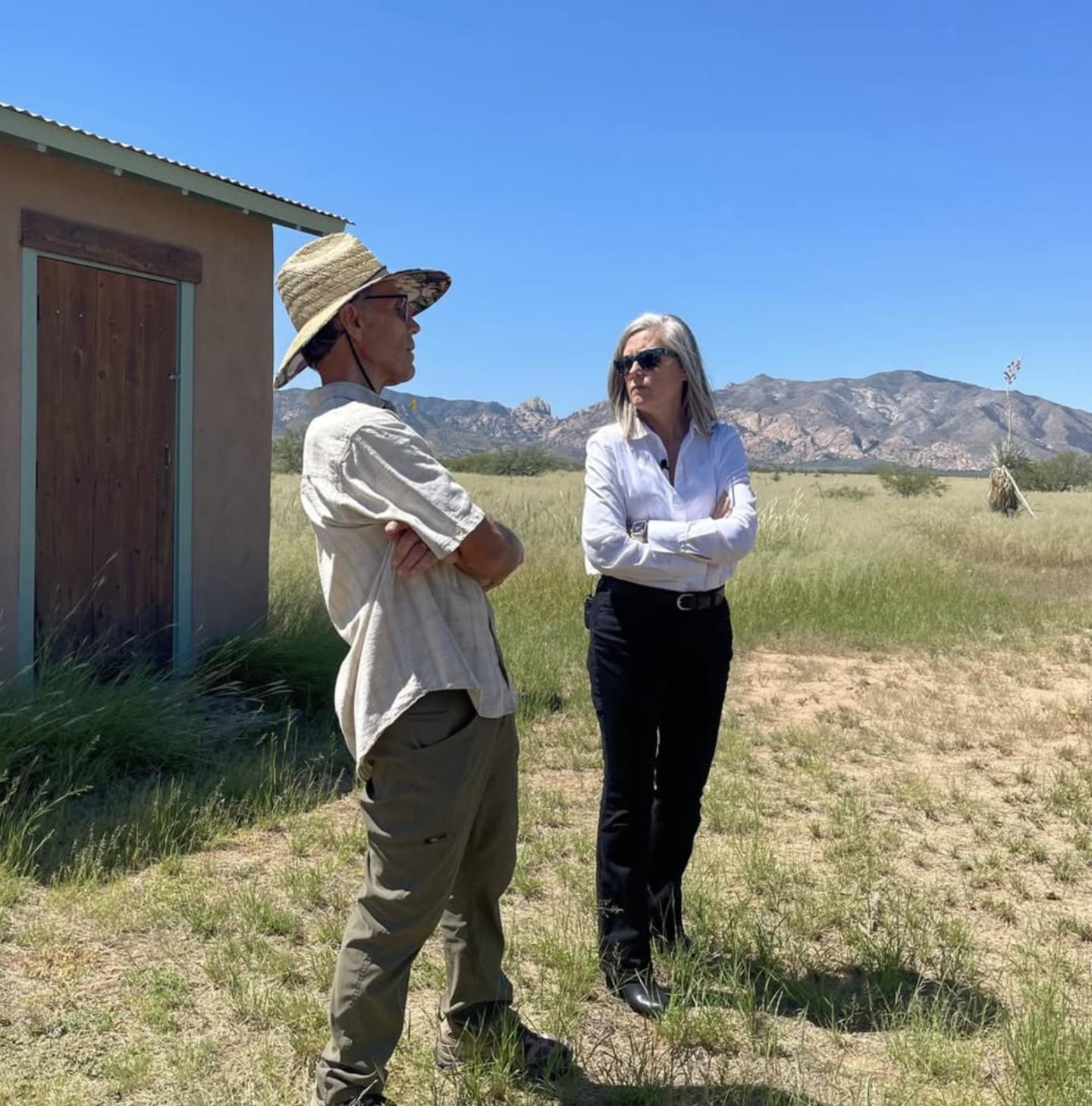 Governor Katie Hobbs and Steve Kisiel standing in front of his home