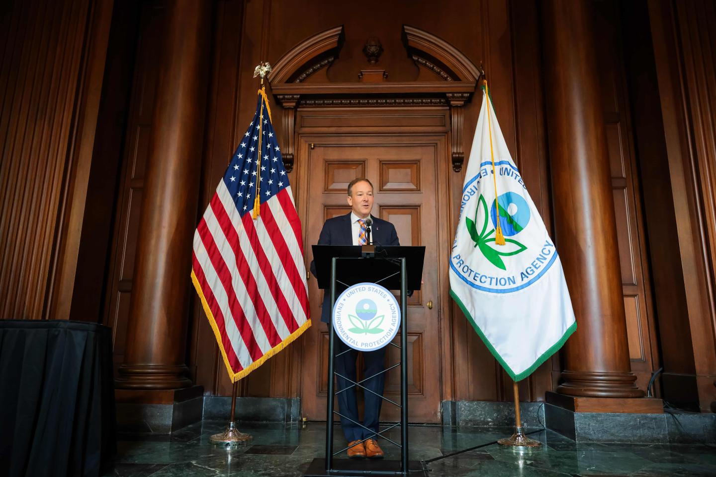 Lee Zeldin standing behind a podium