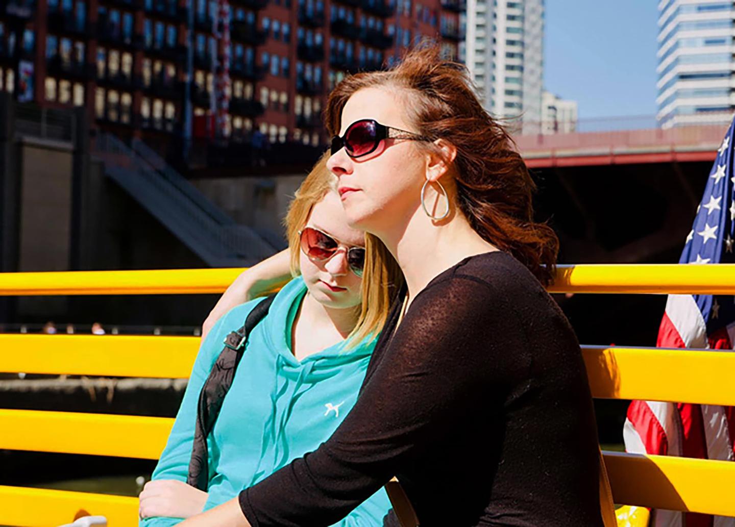 Kari Rhinehart and her daughter Emma Grace Findley sitting on a bench