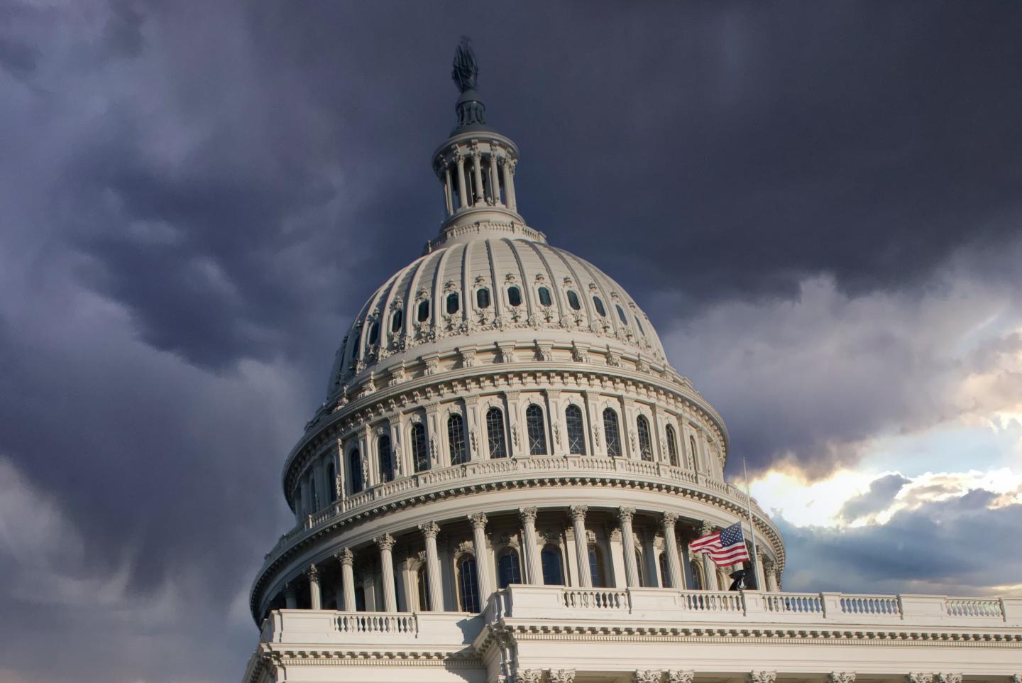 The U.S. Capitol dome with grey clouds behind it