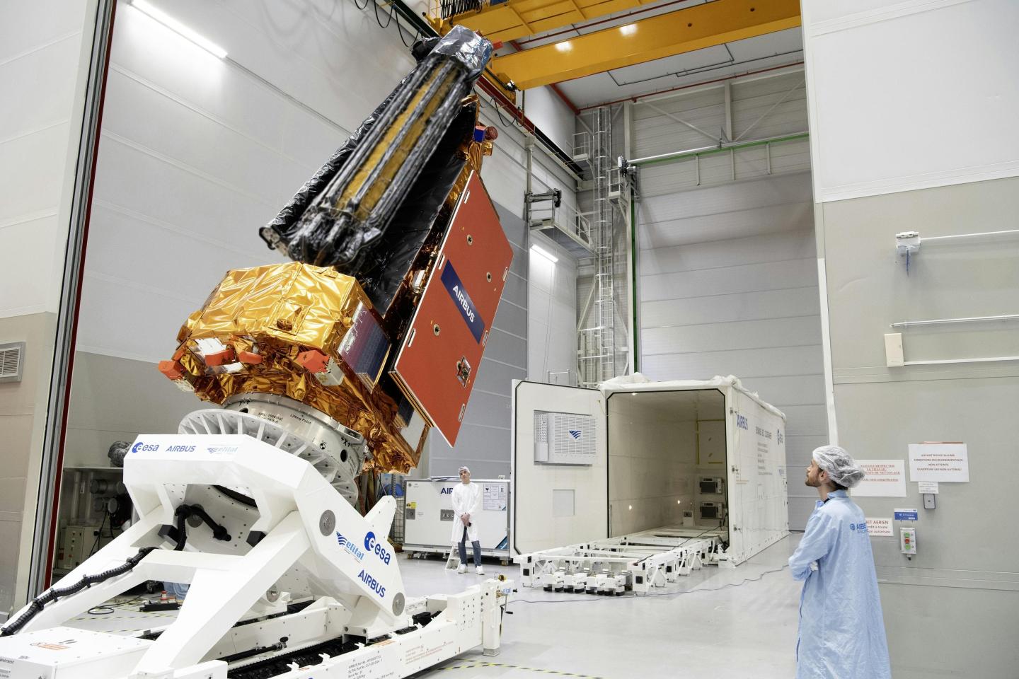 A person looking at a very large satellite