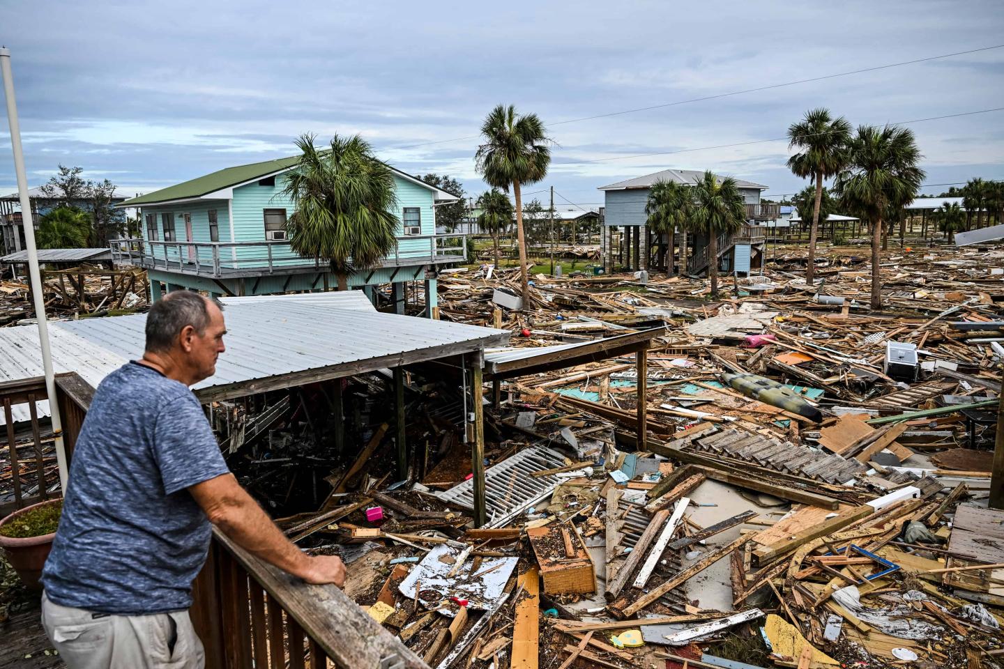 A man surveys damage after a hurricane