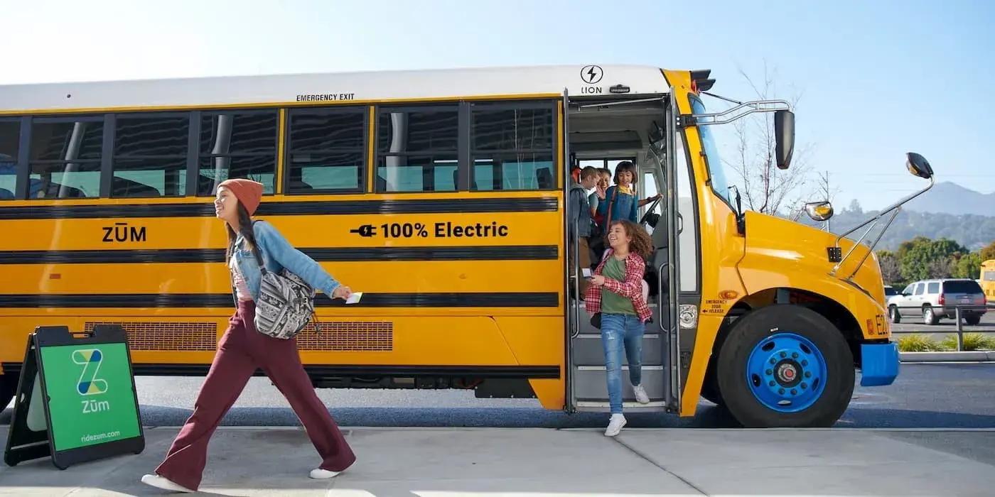 Children getting off an electric school bus