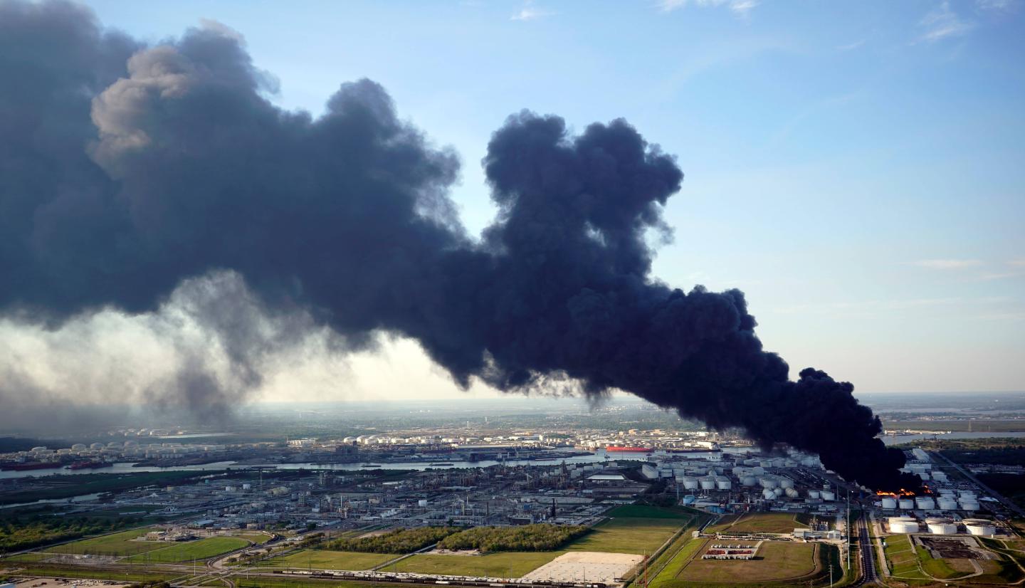 A petrochemical plant on fire and belching out a huge plume of black smoke