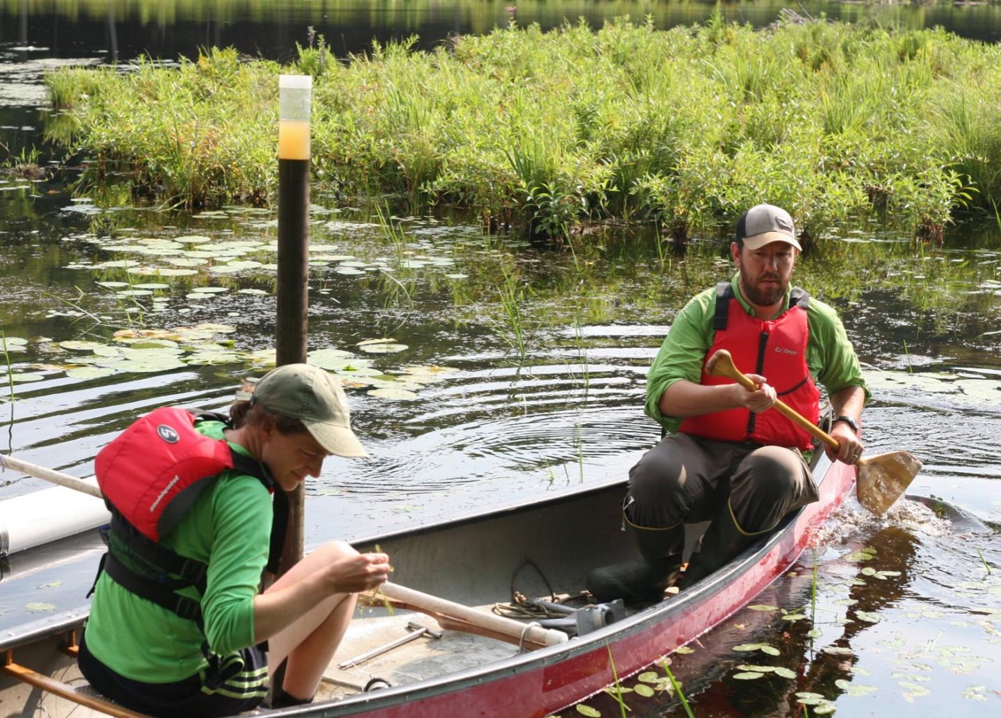 Meredith Holgerson with a teammate on a canoe
