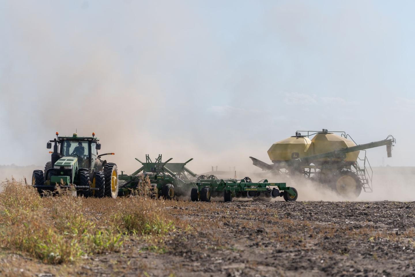 Tractors and vehicles in a dry crop field