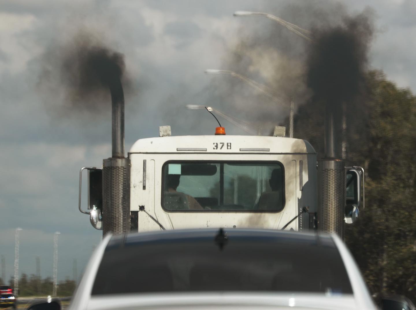 Black exhaust pouring from both sides of a diesel truck