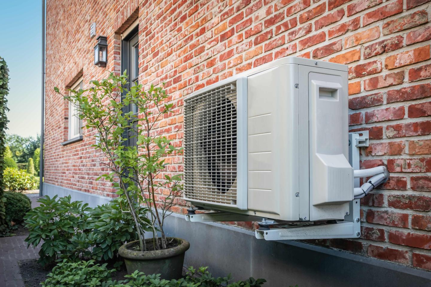 A heat pump on the side of a house
