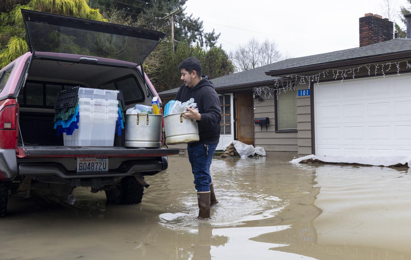 Person loading their truck with supplies in the aftermath of Washington flood