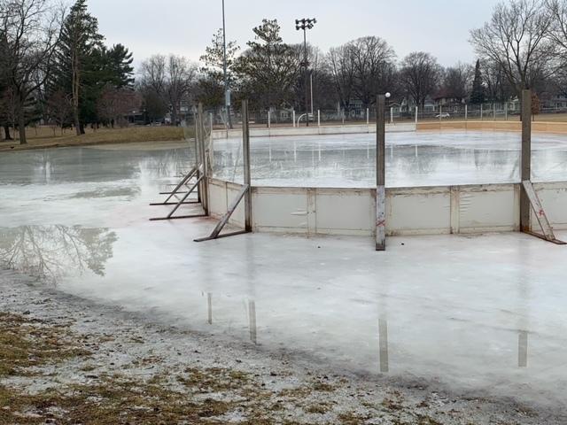 An outdoor ice rink that is on a melting pond
