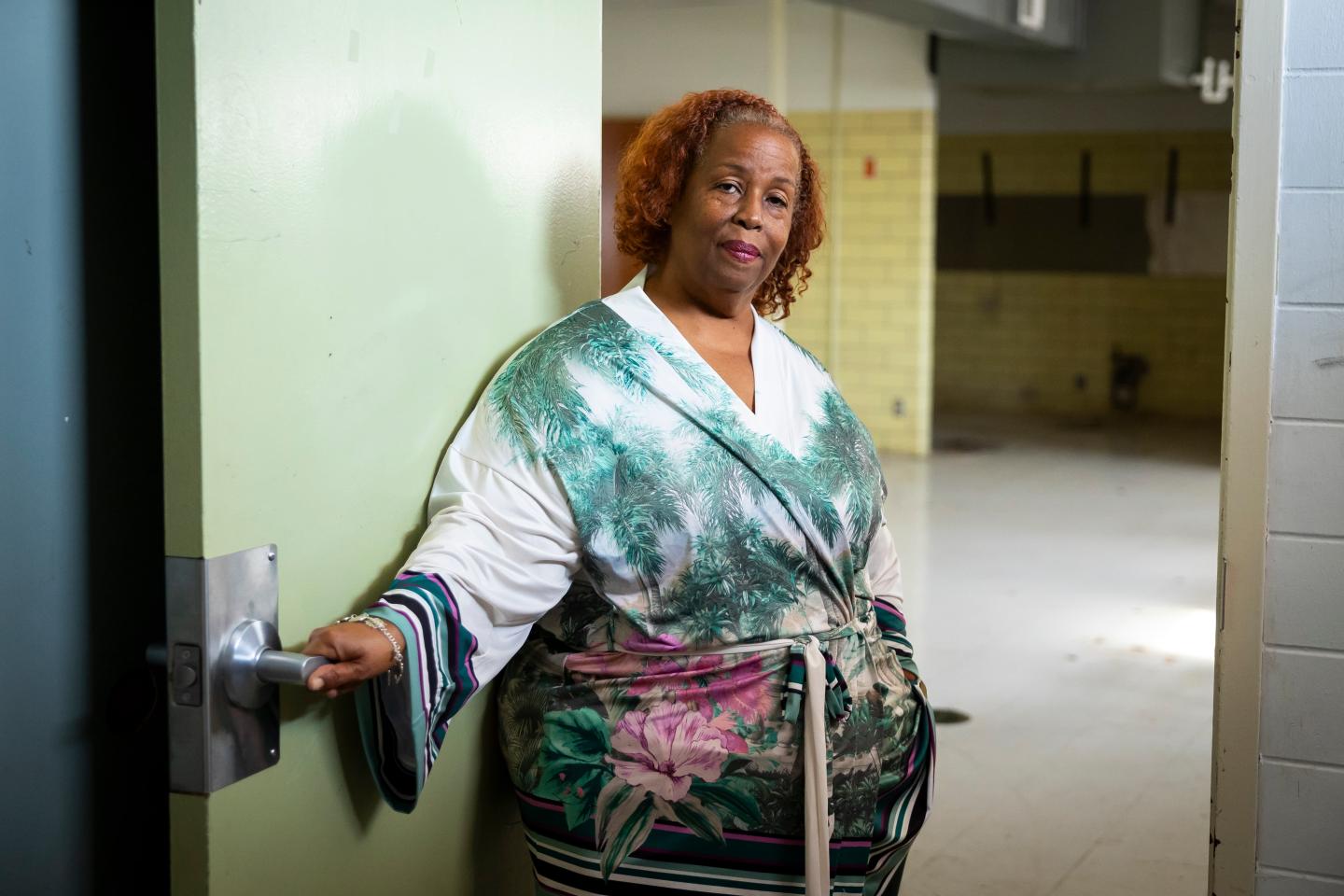 Huey German-Wilson holding a door open inside the school turned resilience hub