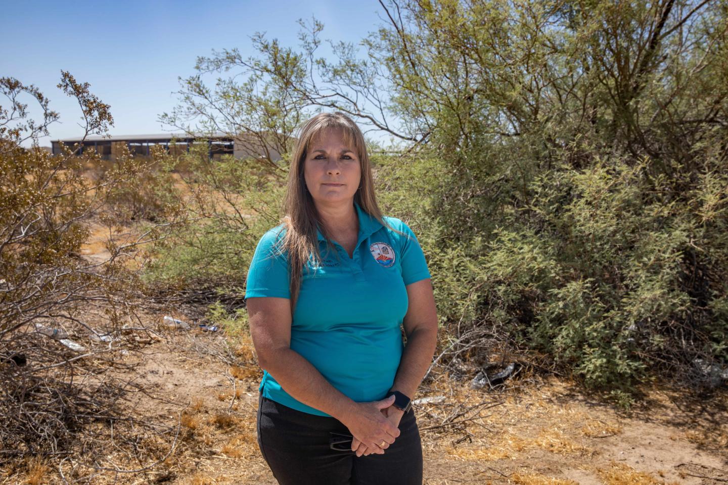 Holly Irwin standing in front of some brush