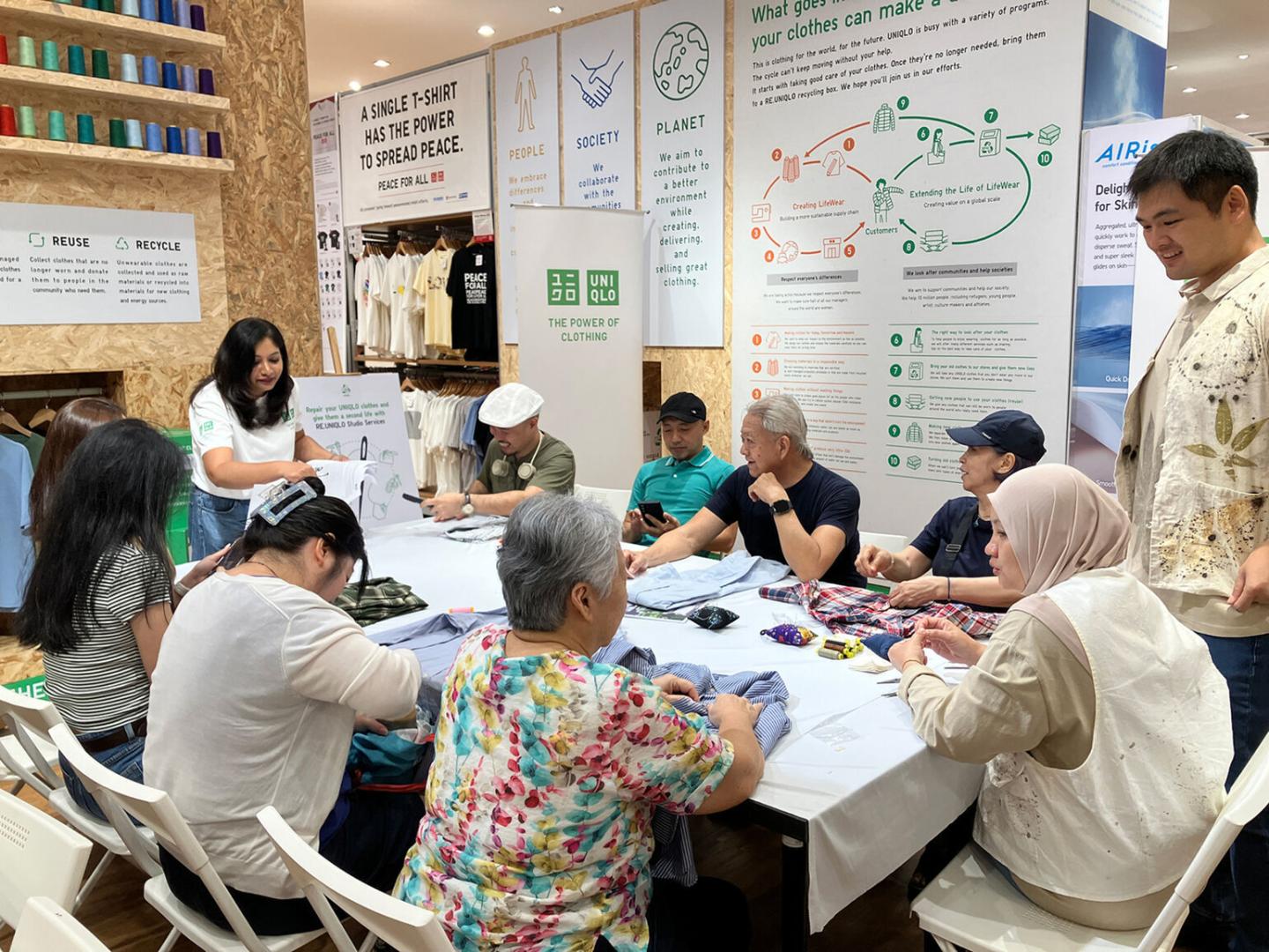 A group of people sitting around a table working on a project