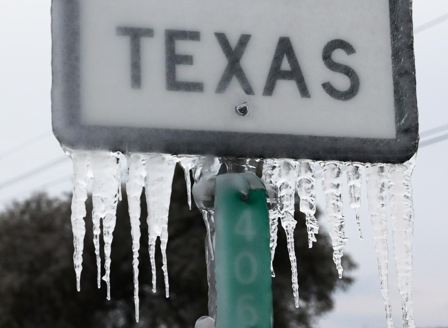 A road sign with Texas on it and icicles hanging down