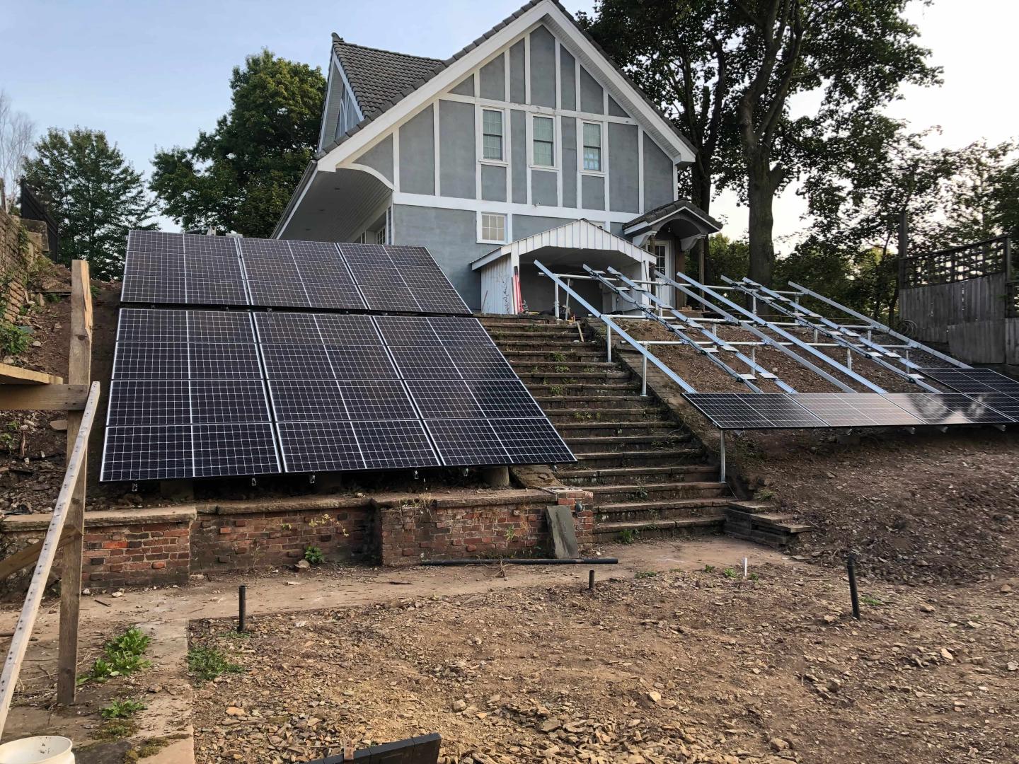 Solar panels in the backyard of a home, partially installed