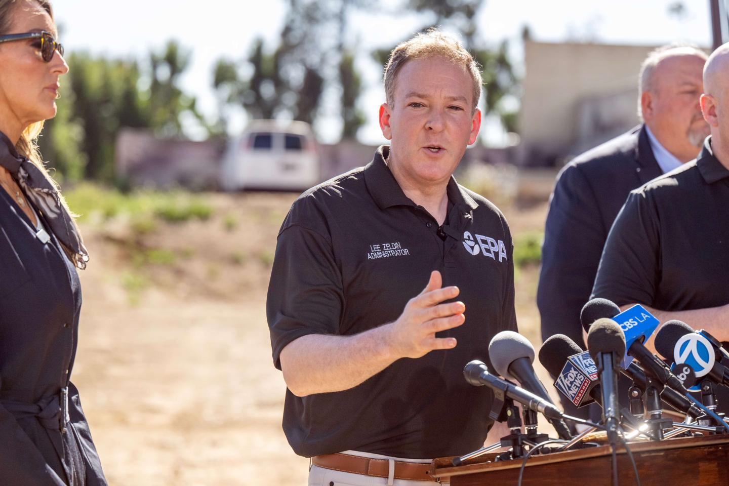 Lee Zeldin speaking at a podium outside