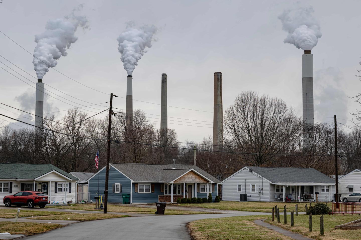 Residential homes in the foreground with smokestacks in the background