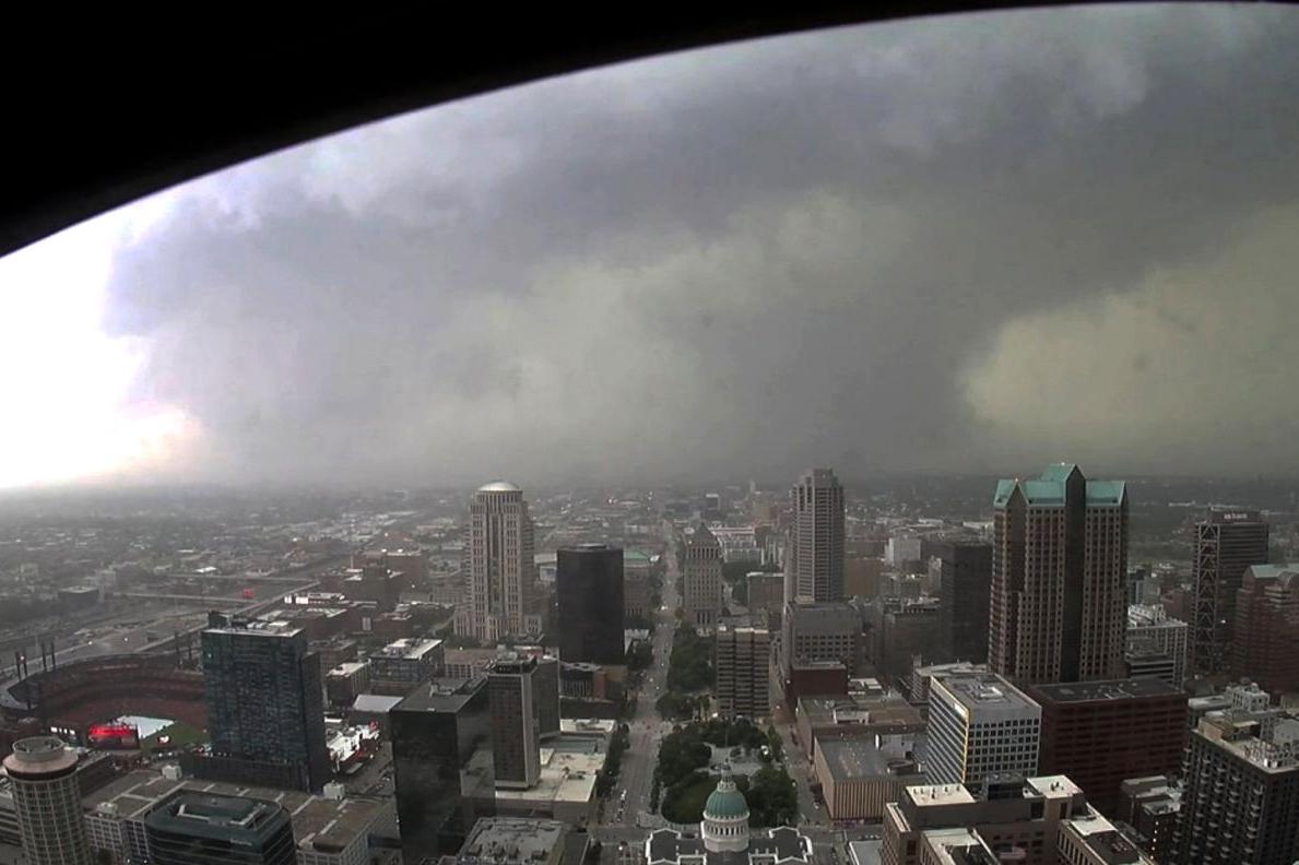A tornado hitting St. Louis as seen through one of the curved windows on the Arch