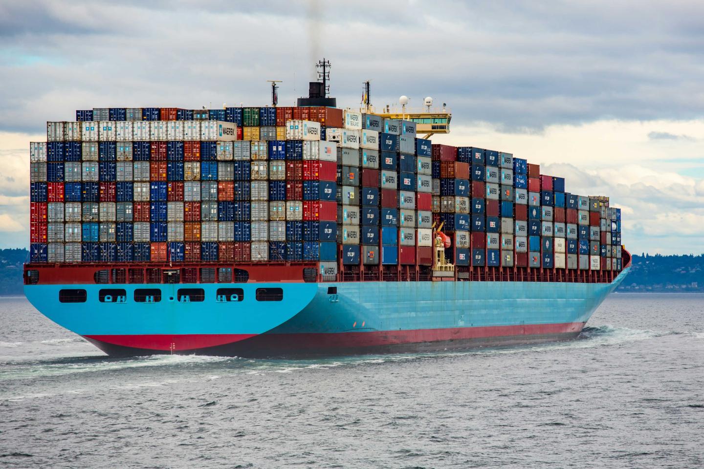 A large ship stacked with colorful shipping containers