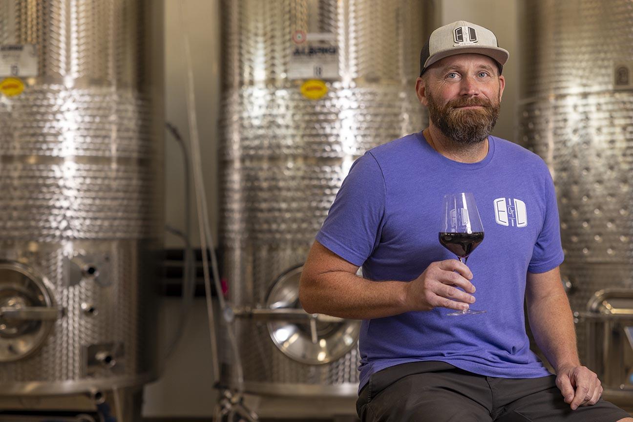 Christopher McIntosh holding a glass of wine