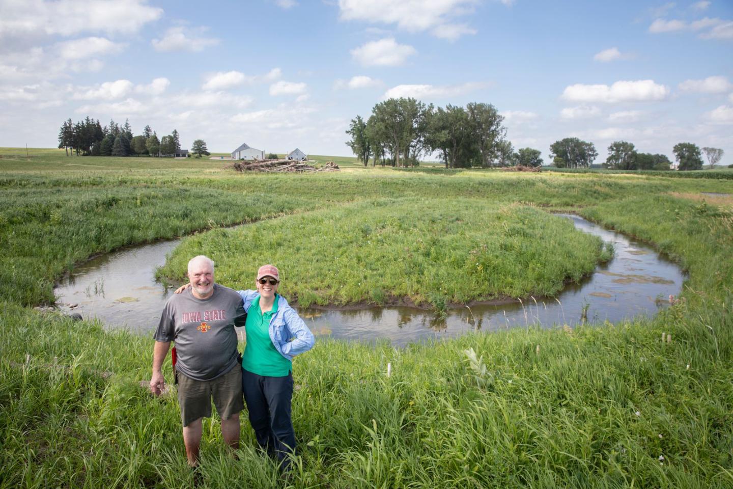 Brad Ohrt and Ruth McCabe stand in front of an oxbow wetland