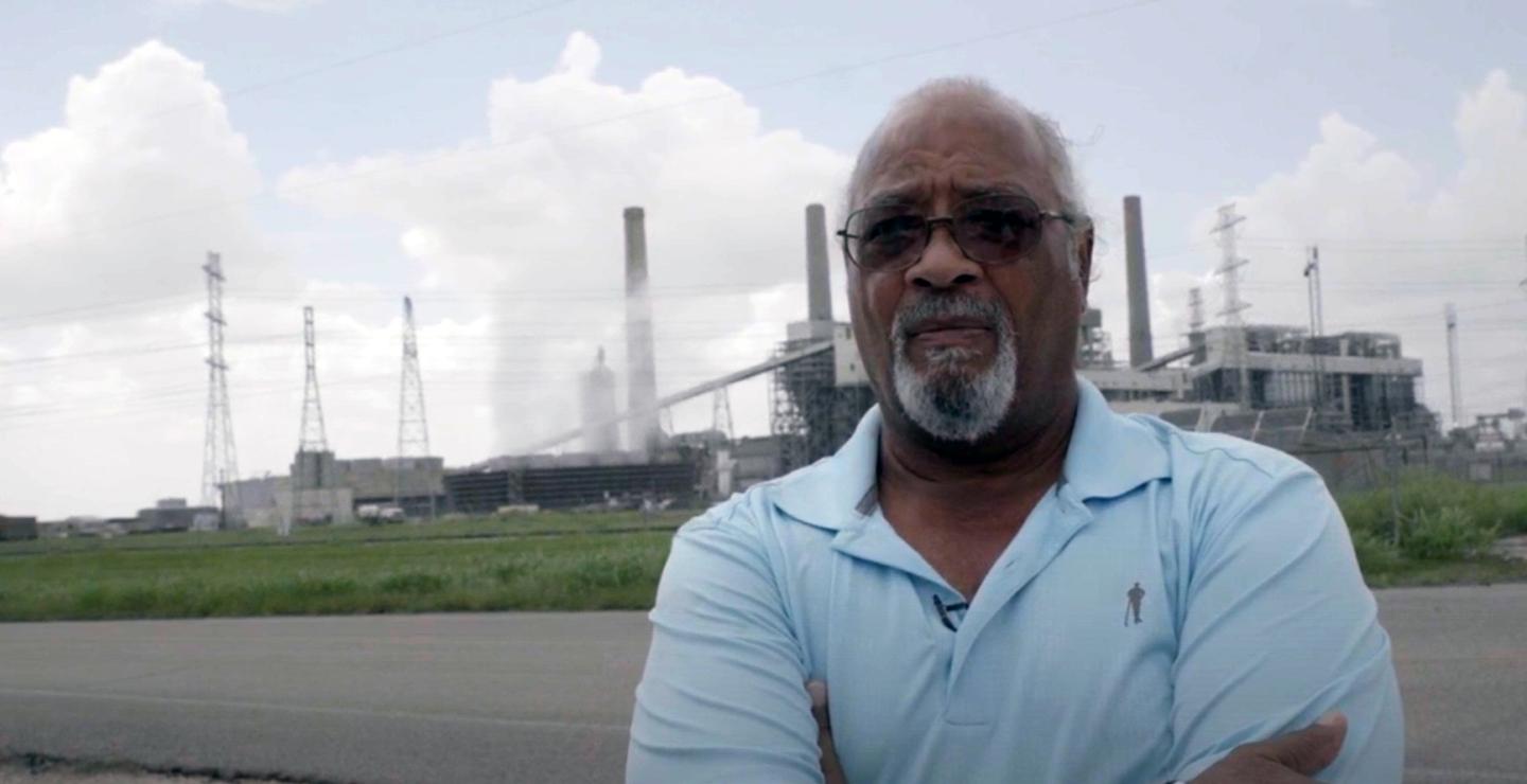 Leroy Wallace standing in front of the Parish power plant