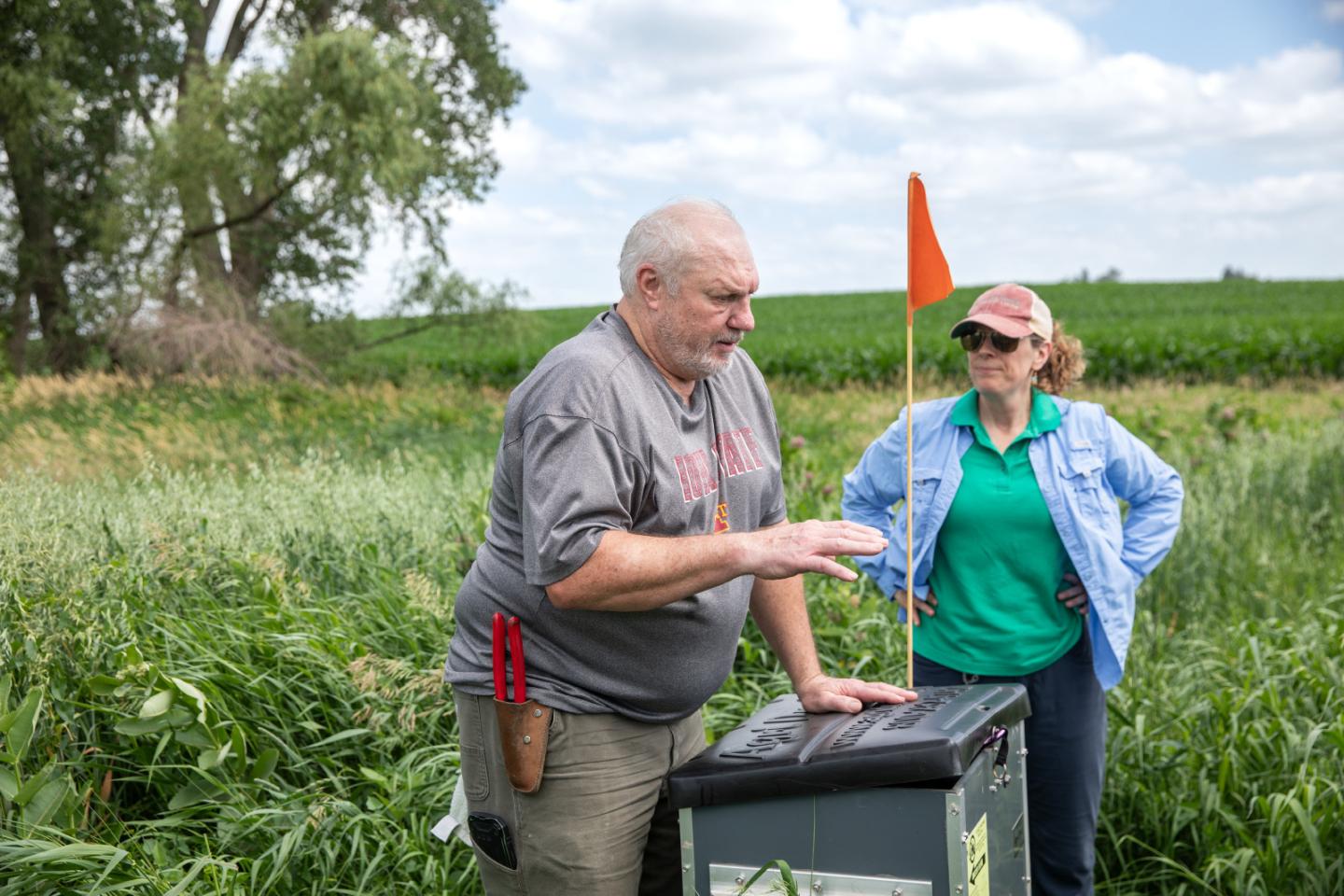 Ruth McCabe and Brad Ohrt stand near a natural filtration system box