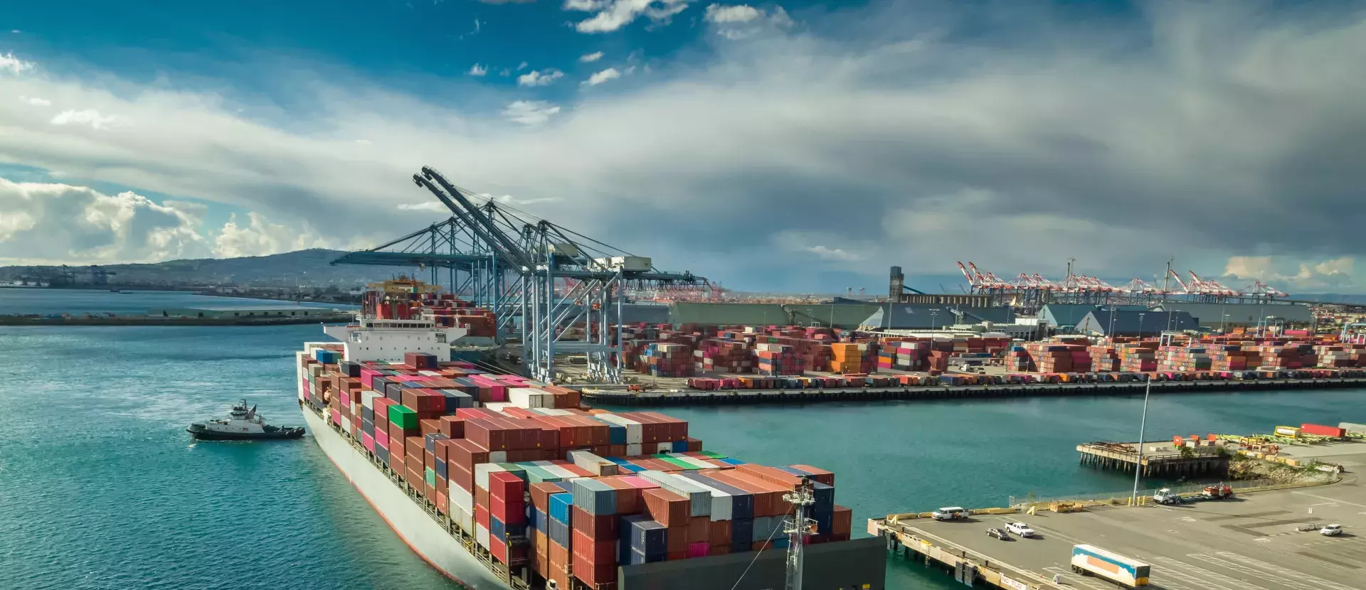 A shipping container loaded up with colorful containers