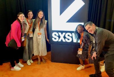 Five Environmental Defense Fund staff members in front of SXSW logo