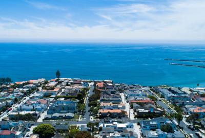 An overhead shot of a coastal town with endless blue water stretching off in the distance. Okay, obviously, not really endless, but it looks endless in the picture