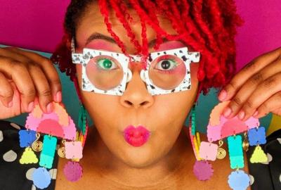 Aaliyah Taylor holds up a pair of her hand-crafted earrings