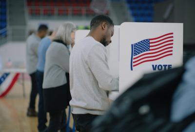 People standing at voting booths