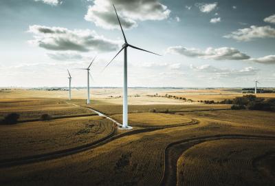 Large wind turbines under a cloudy sky