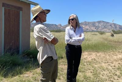 Governor Katie Hobbs and Steve Kisiel standing in front of his home
