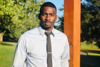 KeShaun Pearson standing near a wooden beam
