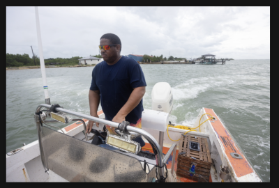 Man piloting a small boat