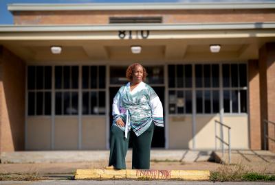 Huey German-Wilson standing in front of a school 