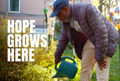 A man gardening with the words "Hope grows here" imposed on the screen next to him