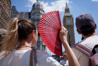 Woman holding a fan with Big Ben in the background