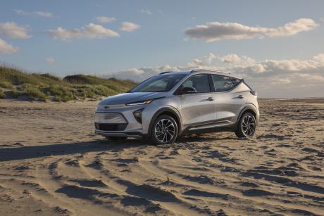 Silver Chevrolet Bolt electric vehicle parked on a beach
