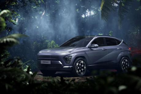 Silver Hyundai Kona electric car parked in lunch jungle with light streaming through canopy from above