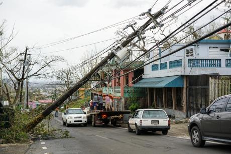 A telephone pole collapsed across a street after a hurricane hit Puerto Rico