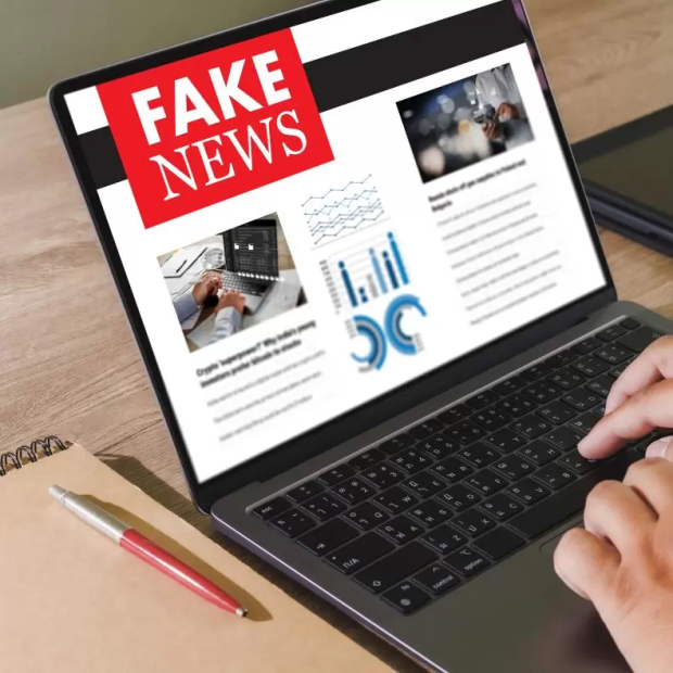 A laptop showing a screen reading fake news