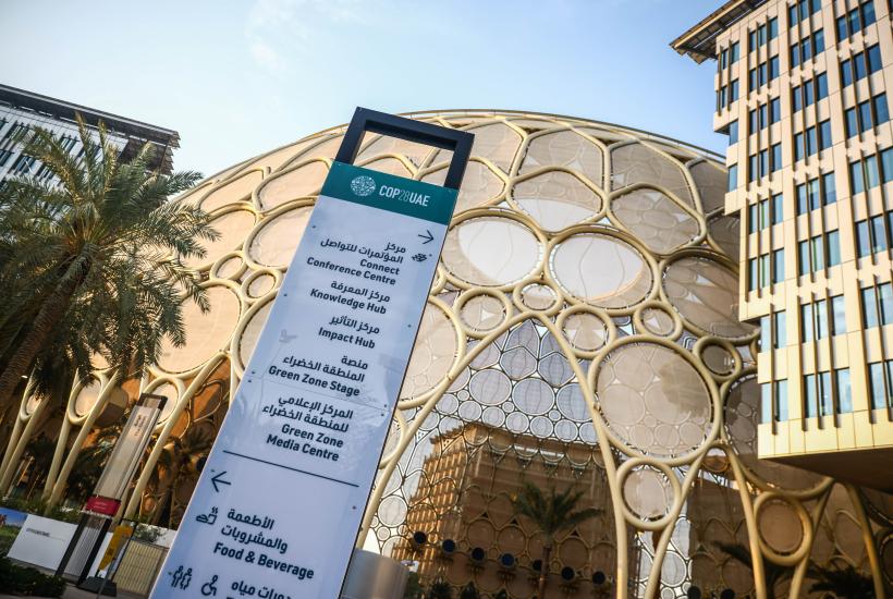 A COP28 sign in front of Expo City Dubai 