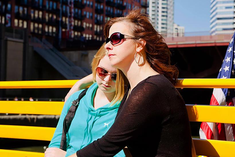 Kari Rhinehart and her daughter Emma Grace Findley sitting on a bench
