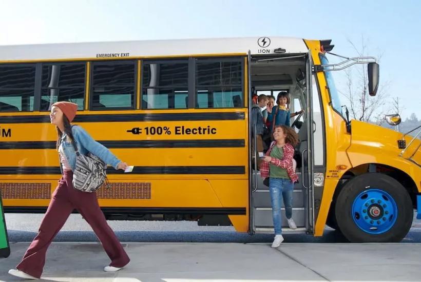 Children getting off an electric school bus