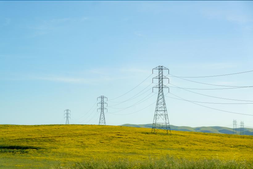 High tension lines cut across rolling hills near San Francisco, USA, weaving a modern energy network amidst the natural landscape.